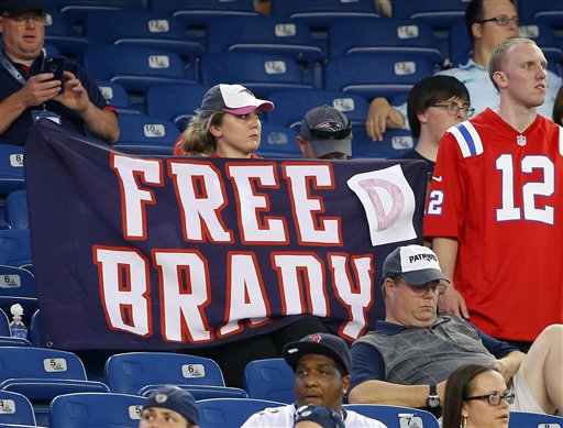 A New England Patriots fan holds a sign referring to Patriots quarterback Tom Brady before an NFL preseason football game between the Patriots and the New York Giants Thursday, Sept. 3, 2015, in Foxborough, Mass. Federal Judge Richard M. Berman overturned NFL Commissioner Roger Goodell's four-game suspension of Brady Thursday morning. The league said it will appeal the ruling. (AP Photo/Winslow Townson)