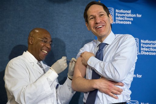 Centers for Disease Control and Prevention Director Dr. Tom Frieden, right, laughs as he receives a flu shot from nurse B.K. Morris during an event about flu vaccinations, Thursday, Sept. 17, 2015, at the National Press Club in Washington. It's time for flu shots again, and health officials expect to avoid a repeat of the misery last winter, when immunizations weren't a good match for a nasty surprise strain.  (AP Photo/Jacquelyn Martin)