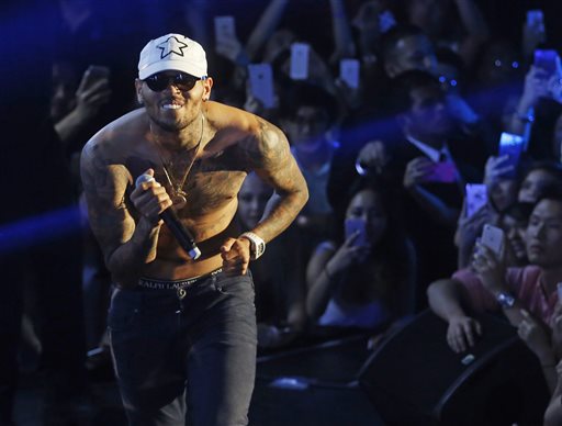 In this July 25, 2015 file photo, Grammy award-winning singer Chris Brown performs at a club in Macau. A government minister signaled Thursday, Sept. 24, 2015 that troubled R&B singer Chris Brown won't be allowed to tour Australia in December because of his criminal conviction for assaulting pop star Rihanna. (AP Photo/Kin Cheung, File)