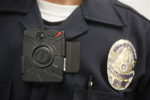 In this Jan. 15, 2014 file photo a Los Angeles Police officer wears an on-body camera during a demonstration in Los Angeles. The Los Angeles Police Departments effort to equip officers with body cameras has run up against an unlikely obstacle, the ACLU of Southern California. The civil rights organization sent a letter Thursday, Sept. 3, to the U.S. Justice Department urging it to deny funding for the cameras until the LAPD revamps its camera policy, which the ACLU said is seriously flawed. (AP Photo/Damian Dovarganes, File)