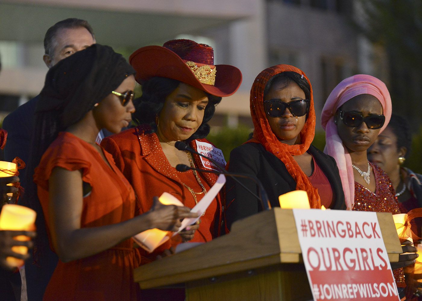 A Chibok school girl that escaped the Boko Haram kidnapping two years ago (left) reads from a list of names of the girls that are still missing as Rep. Frederica Wilson (D-Fla.) looks on during a candlelight vigil at the State Department in Washington, D.C. on April 20, 2016. (Freddie Allen/AMG/NNPA News Wire)