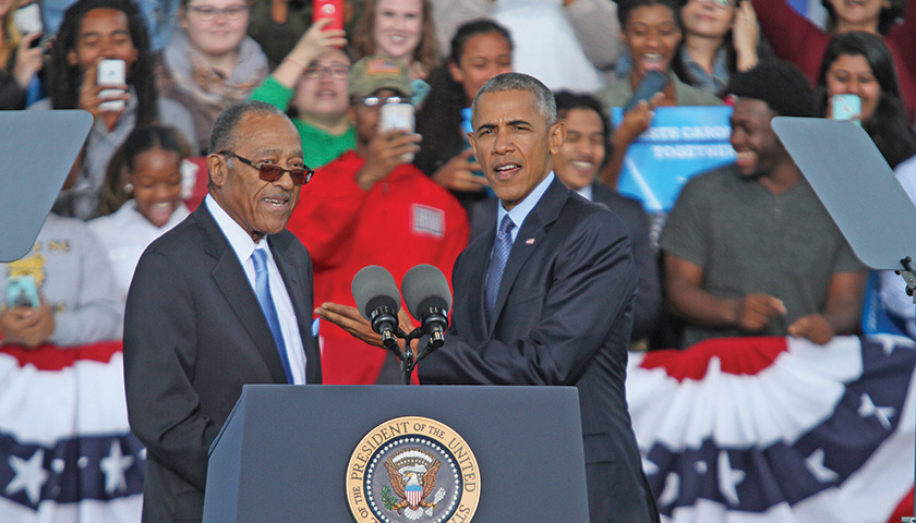 Henry E. Frye, the first African American N.C. Supreme Court Justice, greets President Barack H. Obama, the first African American President of the United States, during a campaign rally for Democratic presidential nominee Hillary R. Clinton, held Tuesday, Oct. 11, at the White Oak Amphitheatre in Greensboro. (Joe Daniels/ Carolina Peacemaker)