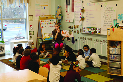 Four-year olds sit for a pre-school staple: listening to a story.
