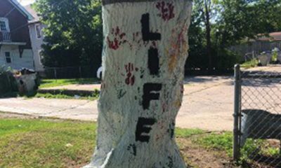 Neighborhood children put their handprints on the white trees. (Picture taken by Nyesha Stone)