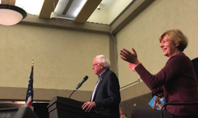 Bernie Sanders speaking at the rally with Tammy Baldwin by his side. (Photo by Nyesha Stone)