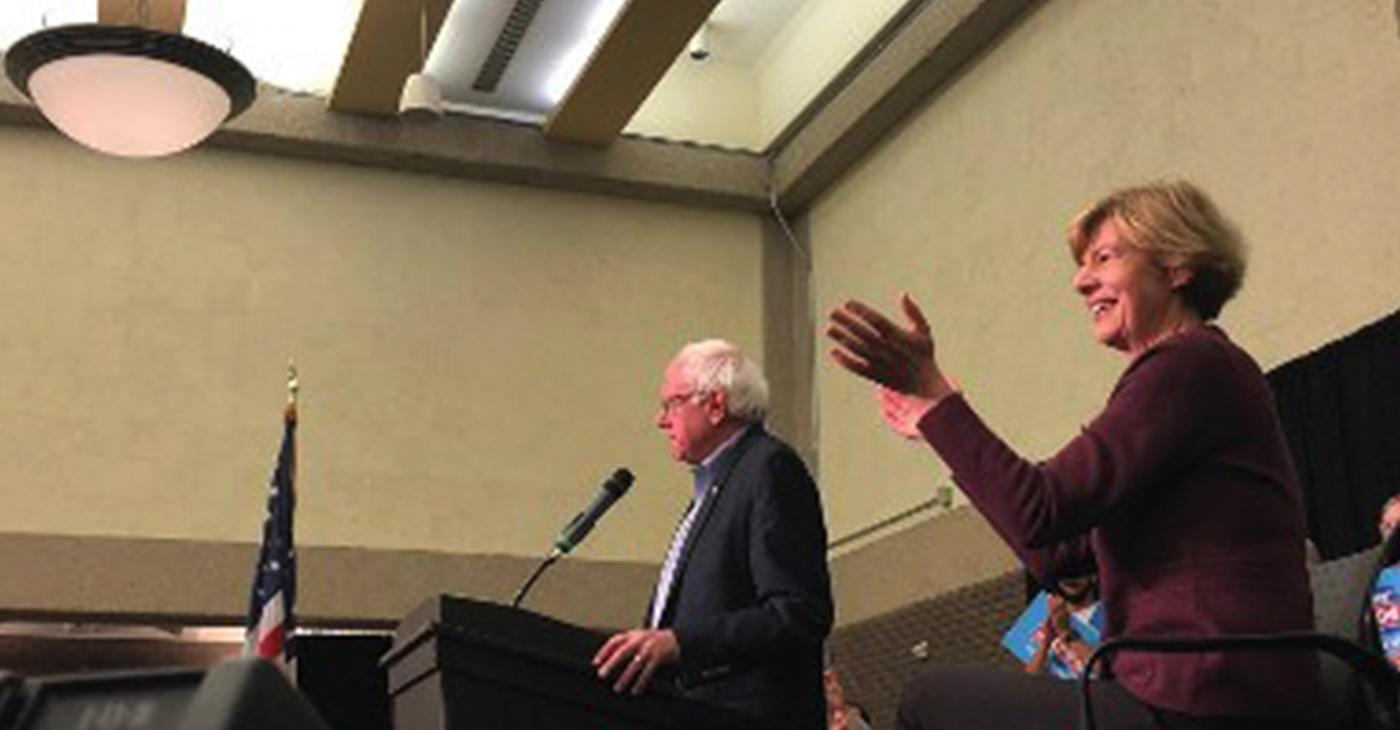 Bernie Sanders speaking at the rally with Tammy Baldwin by his side. (Photo by Nyesha Stone)