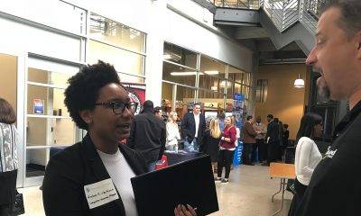 A student speaks with a representative from McLeod Software during the Code the Classic Career Tech Expo. (Erica Wright, The Birmingham Times)