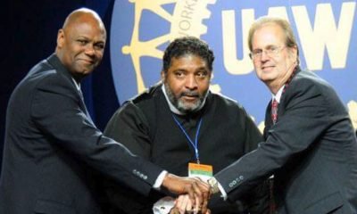 UAW Secretary-Treasurer Ray Curry, Reverend William Barber II, and UAW President Gary Jones stand in solidarity following Rev. Barber's speech on equality.