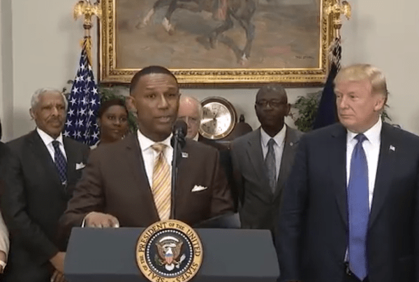 Johnny Taylor Jr., former president of the Thurgood Marshall College Fund, speaks during a Feb. 27 event at the White House to announce his appointment by President Donald Trump (right) as chair of the president's board of advisers for historically Black colleges and universities (HBCUs).