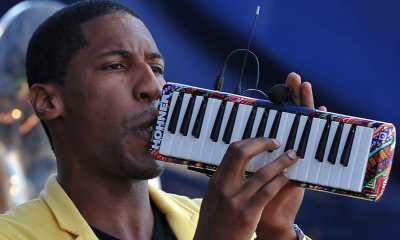 Jon Batiste performs on the melodica.
