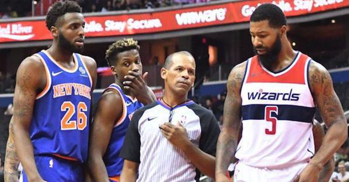 Referee Eric Lewis steps in between Washington Wizards forward Markieff Morris (5) and New York Knicks center Mitchell Robinson after a verbal altercation in the second quarter of the Knicks' 124-121 preseason win at Capital One Arena in D.C. on Oct. 1. (John De Freitas/The Washington Informer)