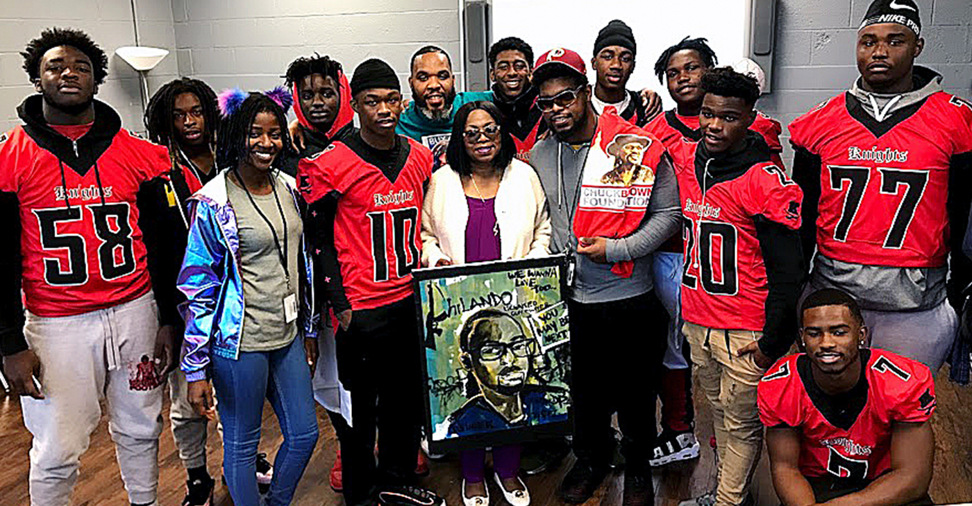 Members of the Majestic Knights football team asked to take a photo with Valerie Castile, center, mother of Philando Castile, her first born son who was killed in 2016 by police during a traffic stop. She gave them advice on ways to stay safe when confronted by the police. / Photo by DR Barnes.