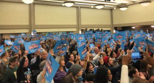 The crowd held Tammy Baldwin signs high in the air to show their support. (Photo by Nyesha Stone)