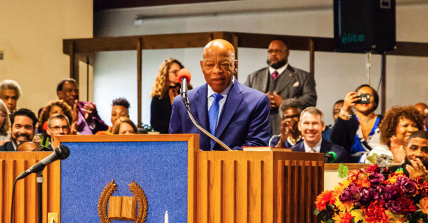 Civil Rights icon and Congressman John Lewis, (D-Georgia), speaks to Cincinnatians at Beloved Community Church in Avondale Sunday. At far left is Aftab Pureval, Democratic candidate for the U.S. House of Representatives in Ohio’s District 1. Seated, in front, is the Rev. Nelson Pierce, pastor at Beloved Community. Photo by Carissa Smith