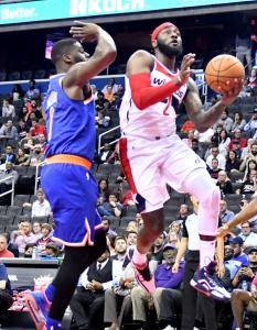 Washington Wizards point guard John Wall drives to the basket past New York Knicks guard Emmanuel Mudiay in the first quarter of the Knicks' 124-121 preseason win at Capital One Arena in D.C. on Oct. 1. (John De Freitas/The Washington Informer)