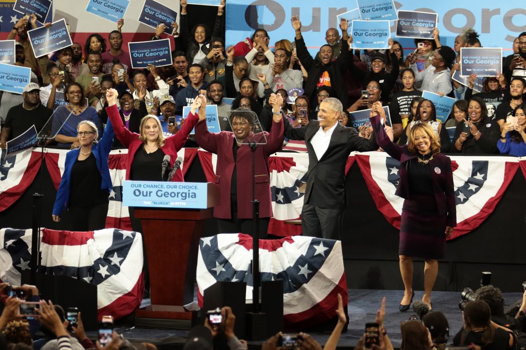 (Left to right) Carolyn Bourdeaux, Sarah Riggs Amico, Stacey Abrams, former U.S. President Barack Obama, and Lucy McBath celebrate on stage at a campaign rally at Morehouse College’s Forbes Arena on Friday, November 2, 2018. (Photo: Itoro N. Umontuen / The Atlanta Voice)