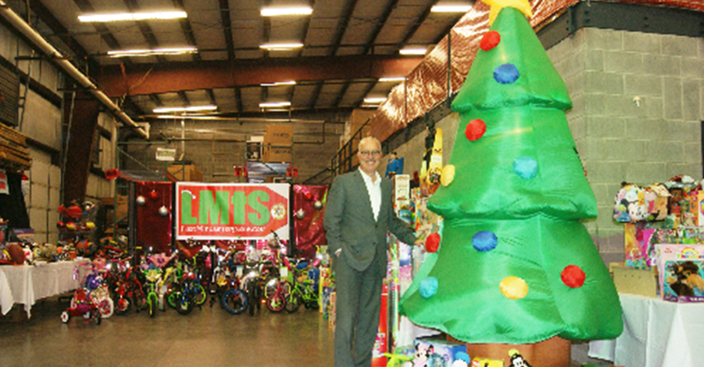Nashville Sheriff Daron Hall in the warehouse holding a fraction of the toys being provided for the Last Minute Toy Store.