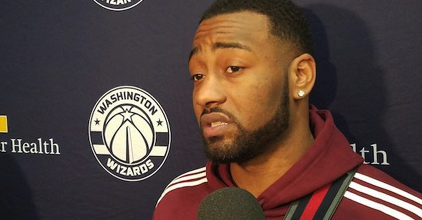 Washington Wizards guard John Wall speaks with reporters after a Dec. 31 practice regarding his upcoming heel surgery, which is expected to keep him out six to eight months. (William J. Ford/The Washington Informer)