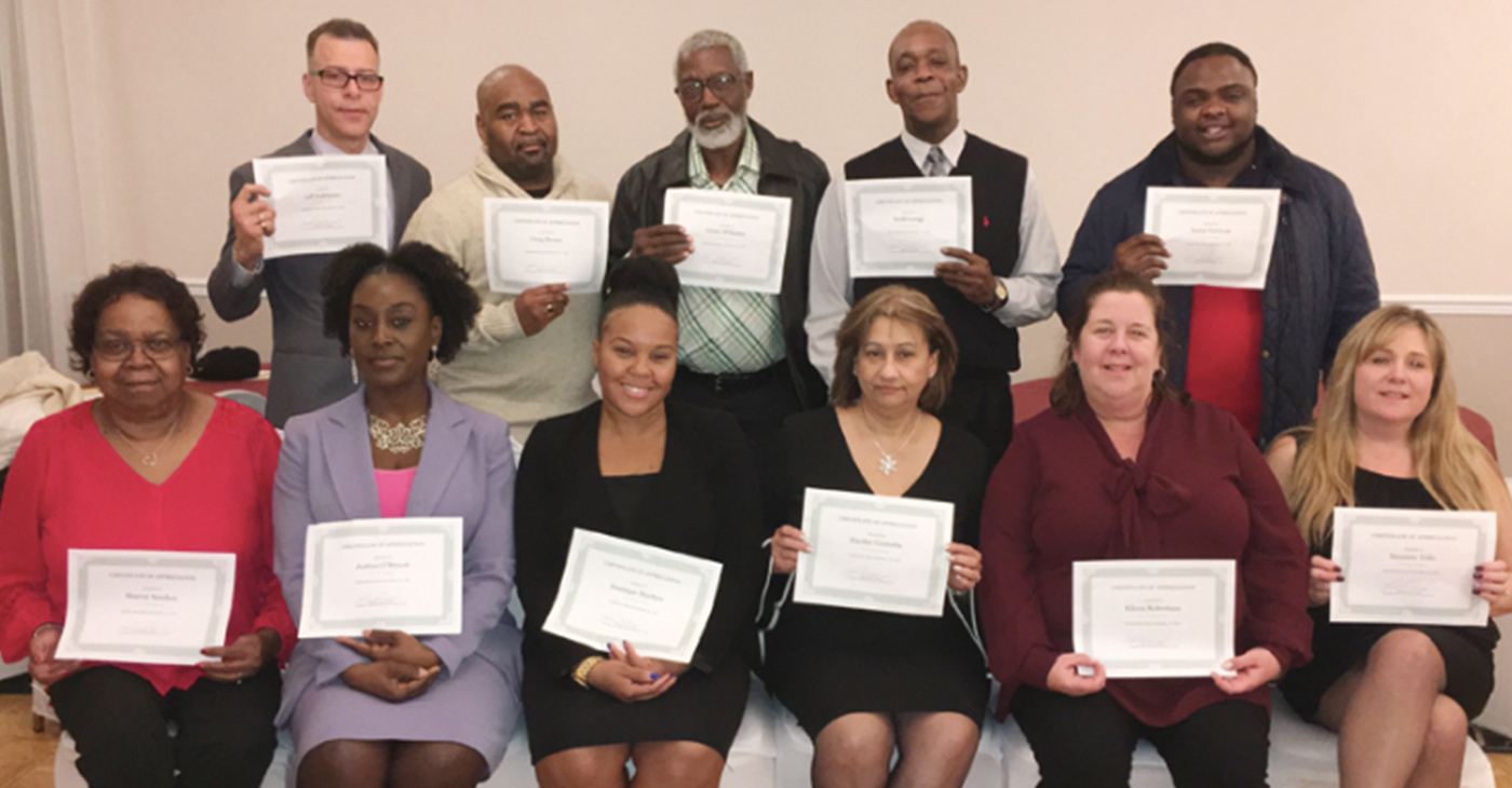 Project L.I.F.E. staff pose with their certificates at their their 1st Annual Christmas Recognition Banquet. By Journalist Ms. Jones