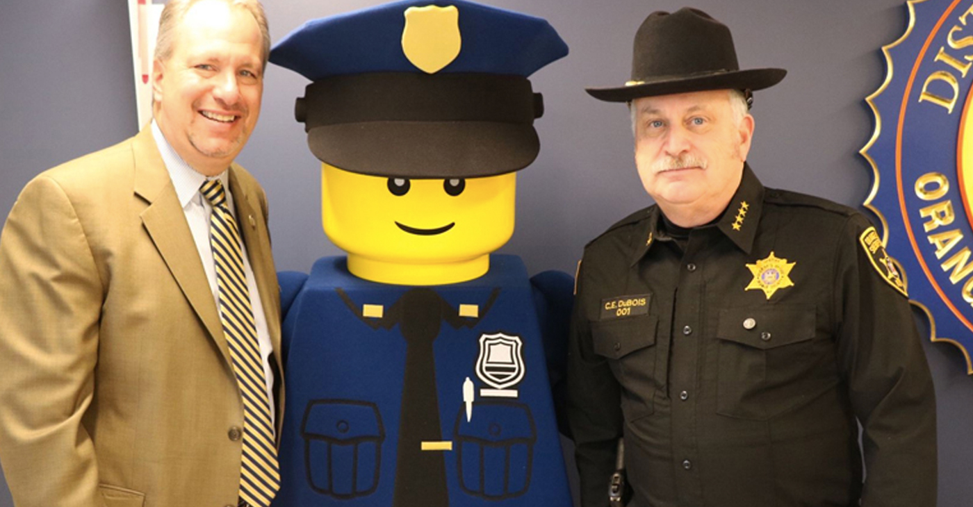 District Attorney David Hoovler (left) and Sheriff Carl E. DuBois (right) with LEGOLAND New York’s “Police Officer Parks” outside of Hoovler’s office at the Government Center.