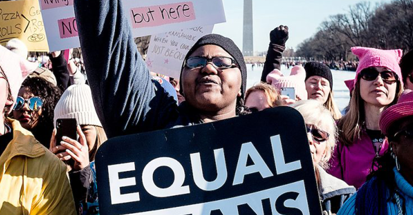 A protester holds a sign at the Lincoln Memorial to rally before the second annual Women's March in D.C. celebrating women's rights on Jan. 20, 2018. (Michael A. McCoy/The Washington Informer)