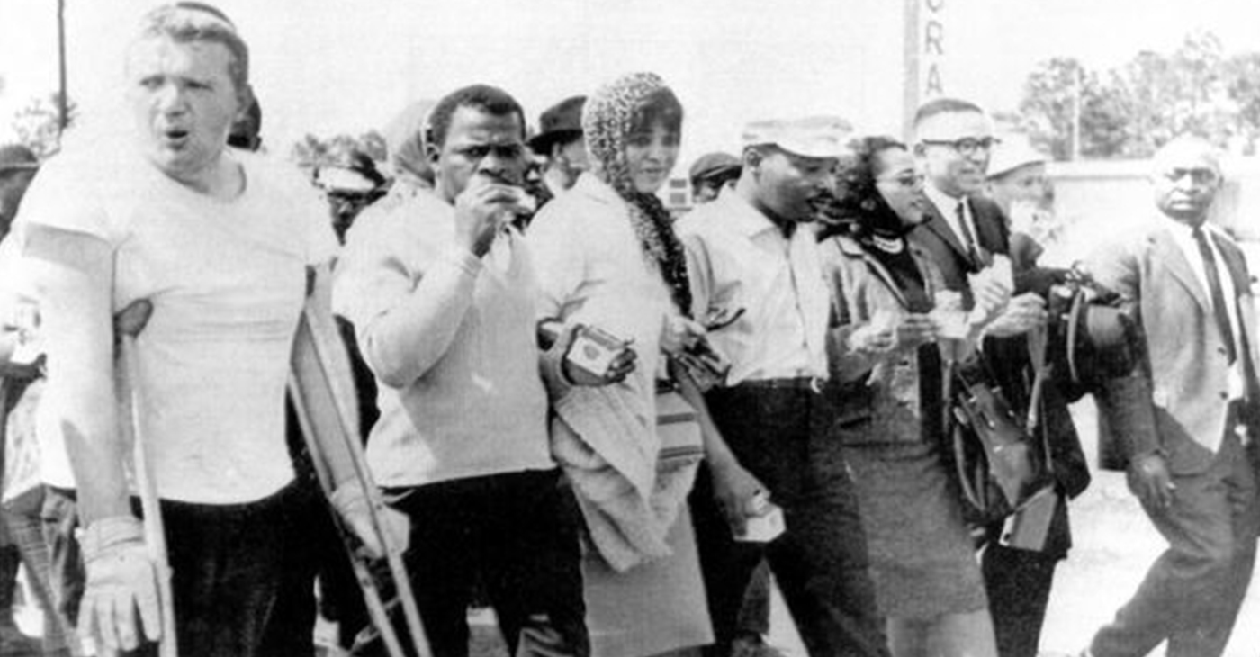 C. Delores Tucker, center, walks hand-in-hand with Rev. Martin Luther King Jr., fourth from left, during a 1965 march in Alabama (Submitted Photo)
