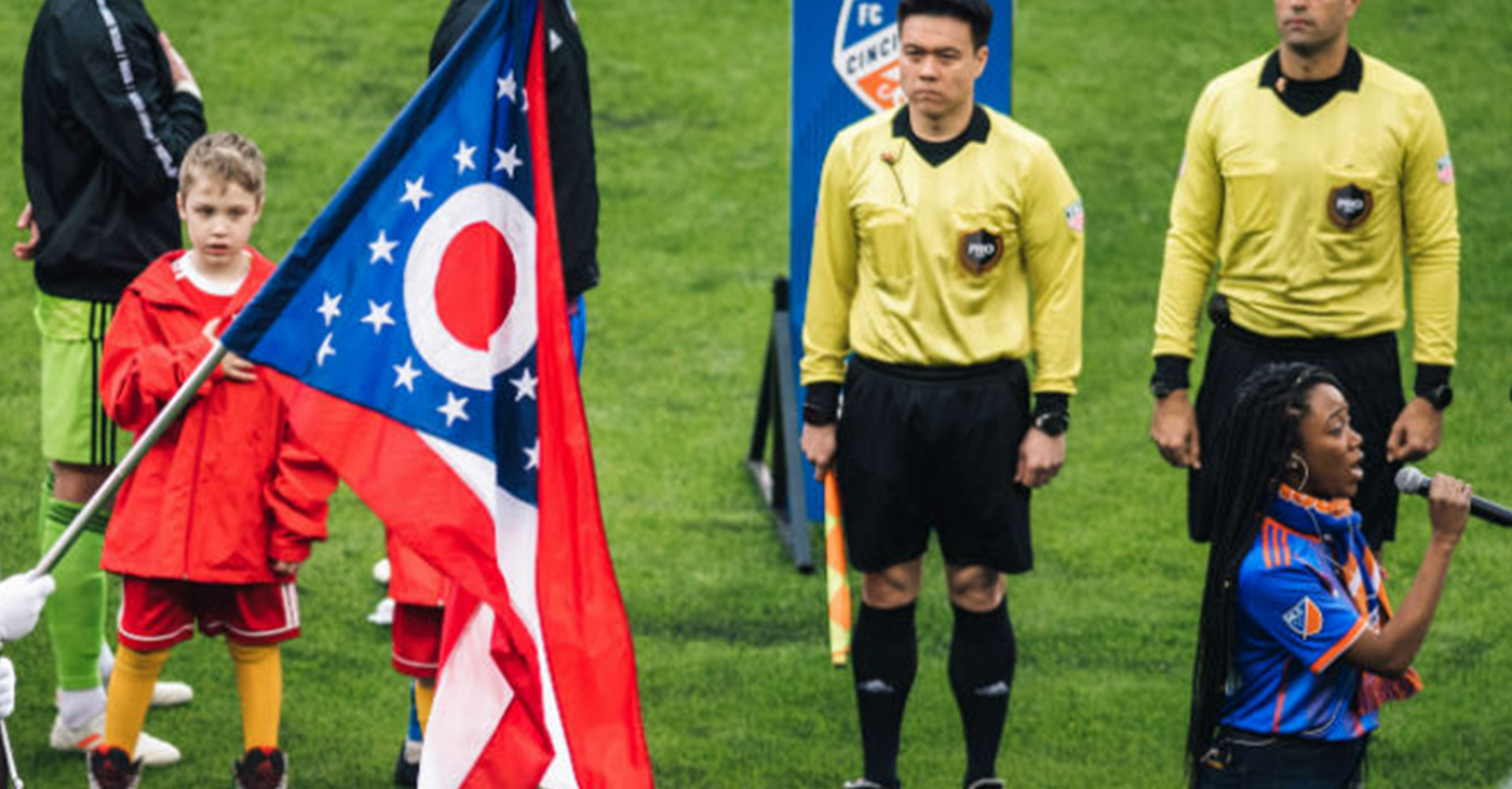 Lauren Eylise, of Cincinnati, sings the National Anthem to kickoff FC Cincinnati’s first home game in Major League Soccer. (Photo by: Ray Ball)
