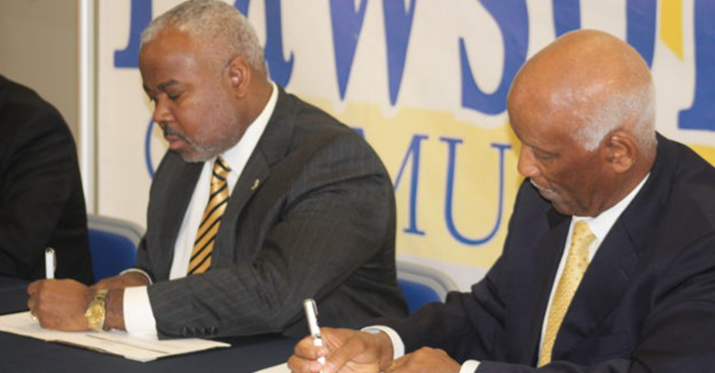 Alabama State President Dr. Quinton Ross Jr. (left) and Lawson State President Dr. Perry Ward sign memorandum of understanding between the two institutions. (Photo by: Ameera Steward | The Birmingham Times)