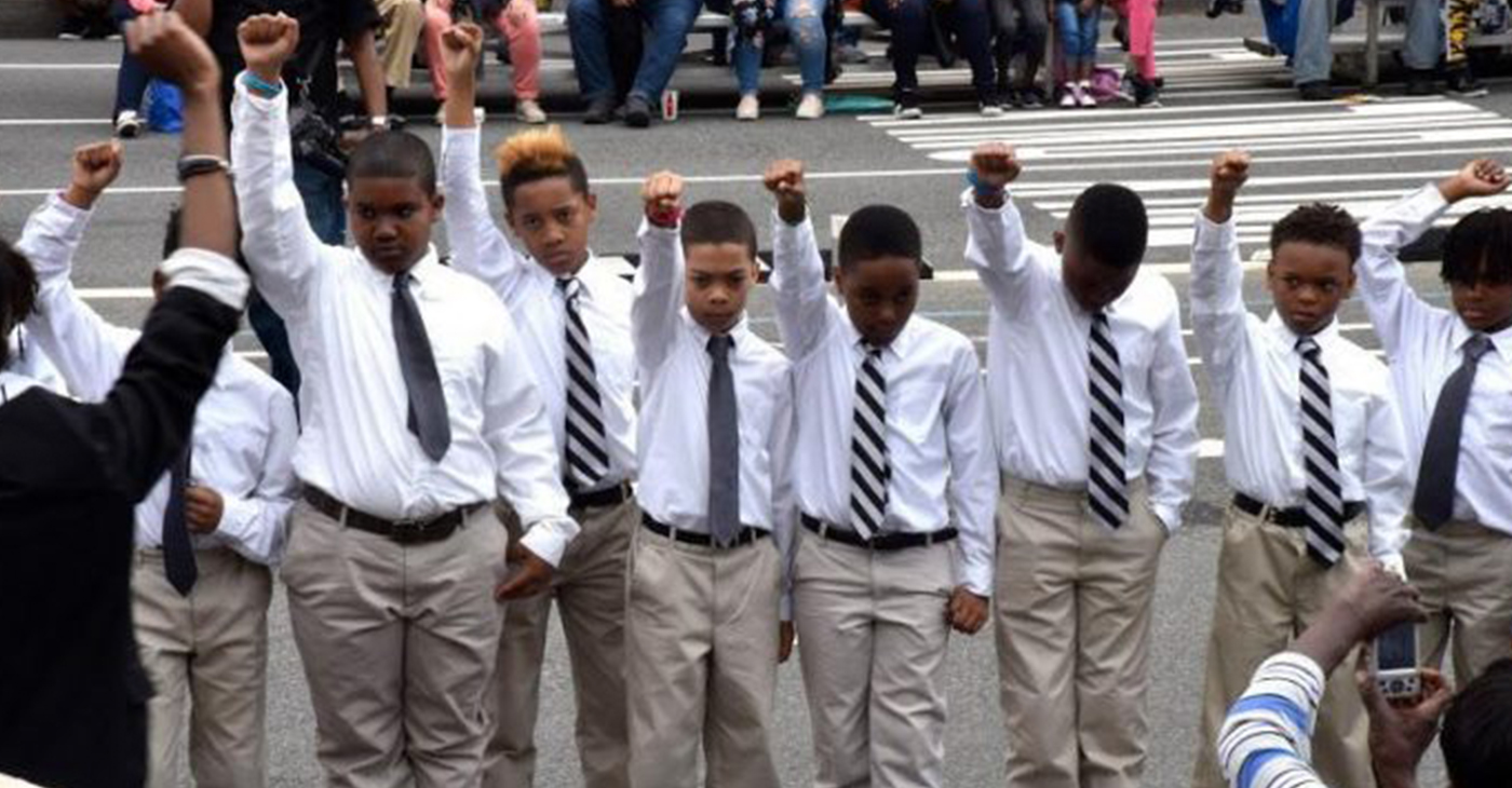 Young men participate in the Emancipation Day parade, putting their fists in the air to symbolize Black power and pride, as the District celebrated 157 years since the abolition of slavery in the city. (Photo by: Rob Roberts)