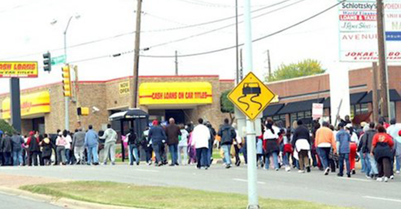 Protesters march in 2015 past one of 17 predatory lending businesses in South Dallas, Texas. (Courtesy of Paul Malbrough)