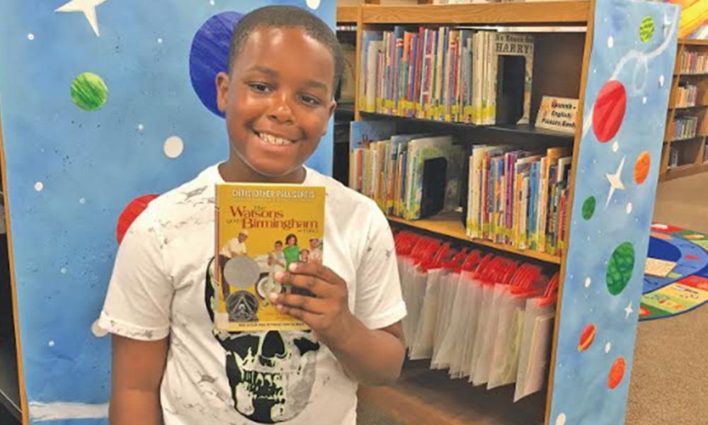 Dalvin McCollum, 10, used his love of comics to create a newspaper, "B'HAM NEWS," that included an article, a drawing of the 16th Street Baptist Church, and a comic strip based on "The Watsons Go to Birmingham 1963." (Photo by: Kathryn Sesser-Dorne | The Birmingham Times)