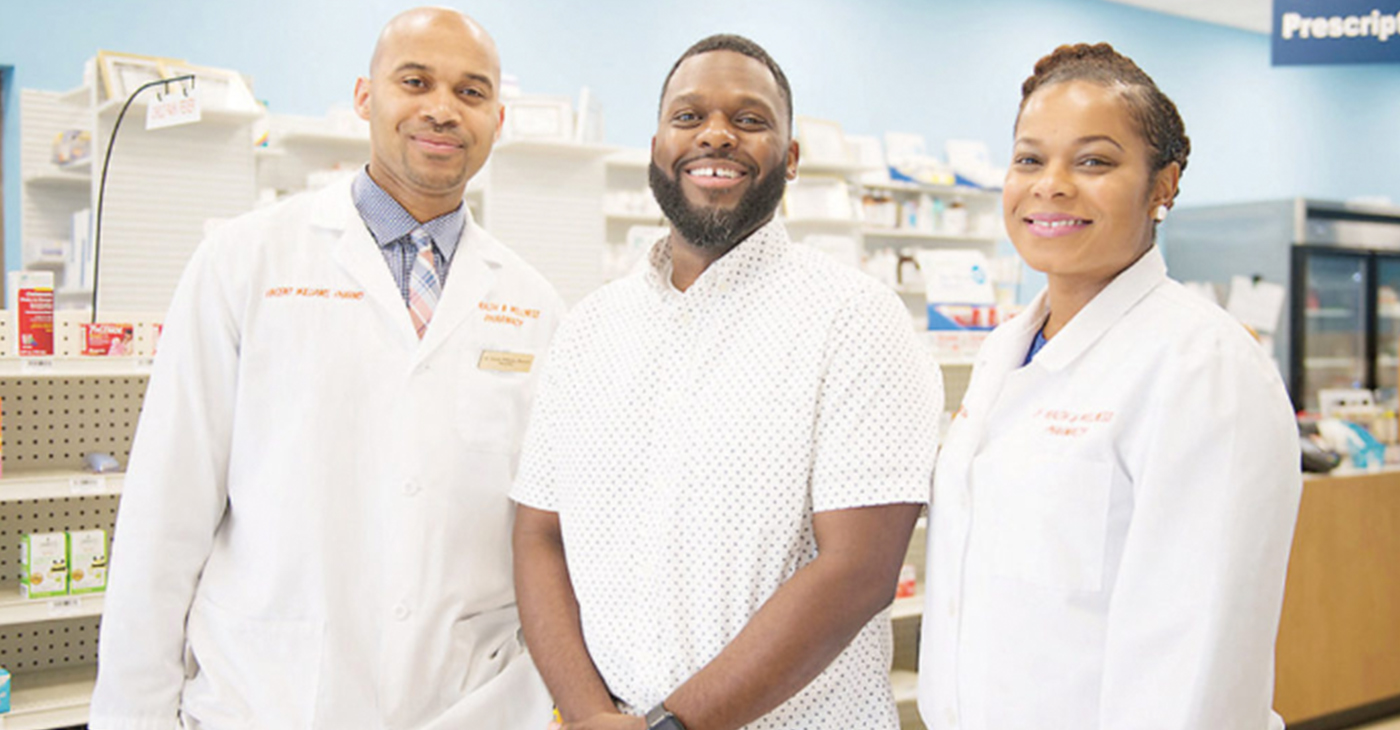 Customer Bernard Macon (center) is shown with Vincent and Lekeisha Williams, owners of LV Health and Wellness Pharmacy in Shiloh, Illinois.