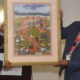Lane College President Logan Hampton (left) and the Rev. Dr. L. LaSimba M. Gray Jr., a Lane College alum, display a framed image that reflects the Lane College historical journey. (Photo: Tyrone P. Easley)