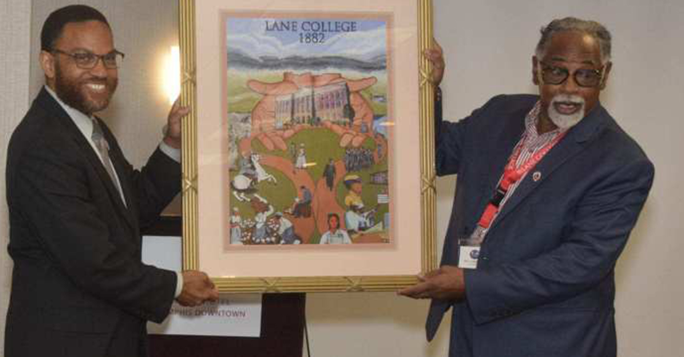 Lane College President Logan Hampton (left) and the Rev. Dr. L. LaSimba M. Gray Jr., a Lane College alum, display a framed image that reflects the Lane College historical journey. (Photo: Tyrone P. Easley)