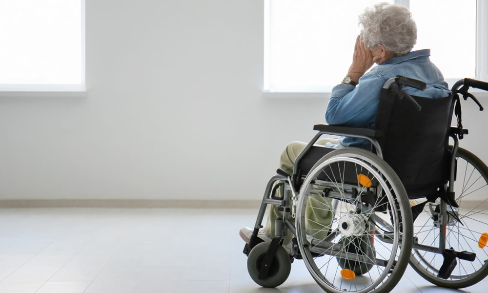 Lonely senior woman in wheelchair indoors (Photo by: Leonid | Adobe)
