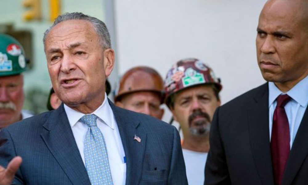 Sens. Chuck Schumer and Cory Booker (Courtesy photo/AM New York)