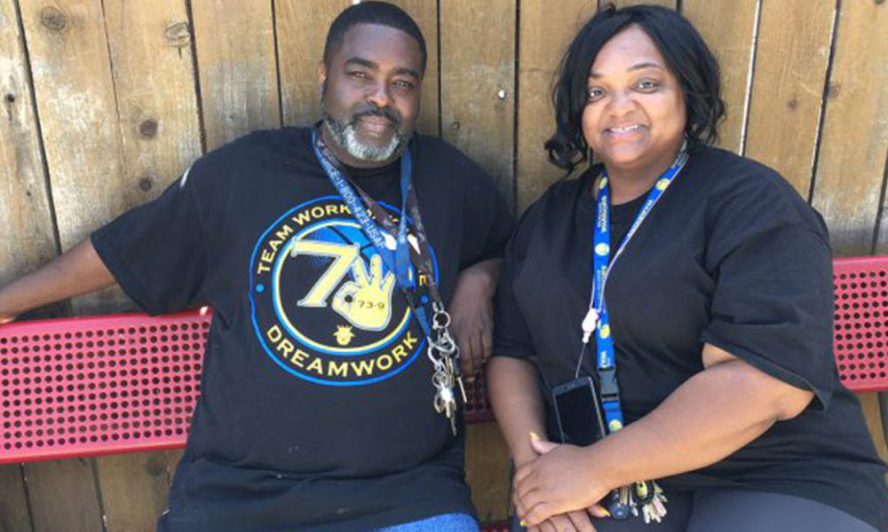 Reach Out Program Manager Charlie Jones, right, and volunteer Lee Frierson, take a short break after leading a game of bingo with mental health patients at an Oakland, California, board-and-care home. (Photo by: Rob Waters)