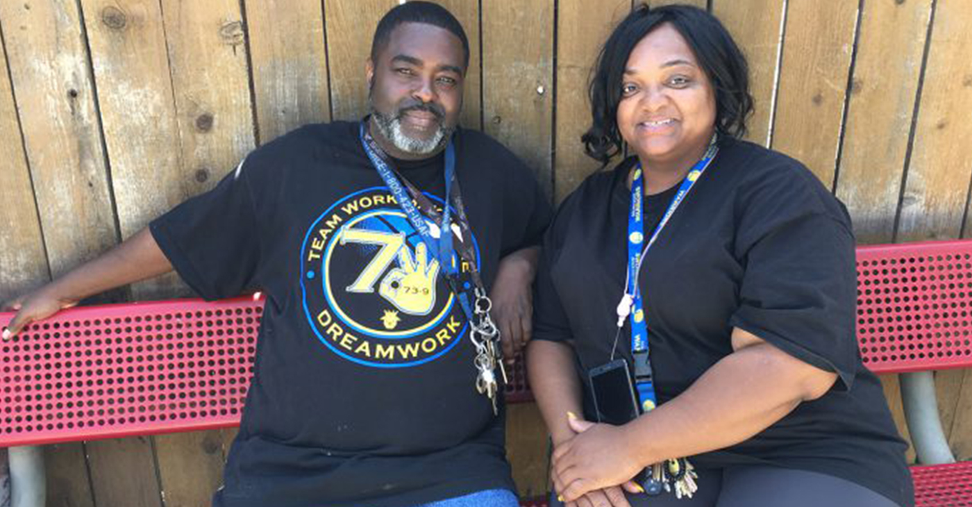 Reach Out Program Manager Charlie Jones, right, and volunteer Lee Frierson, take a short break after leading a game of bingo with mental health patients at an Oakland, California, board-and-care home. (Photo by: Rob Waters)