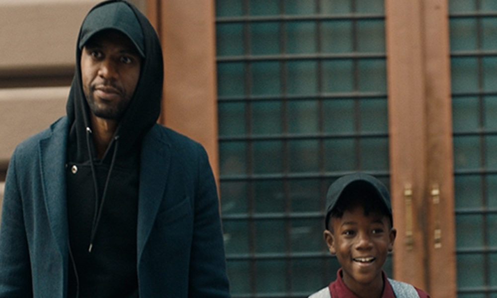 “The Look” follows a Black man throughout his day as he encounters a variety of ‘looks’ that symbolize a barrier to acceptance. In the film, the windows of a passing car are raised after his son waves to a young girl in the back seat. (Photo: Business Wire)