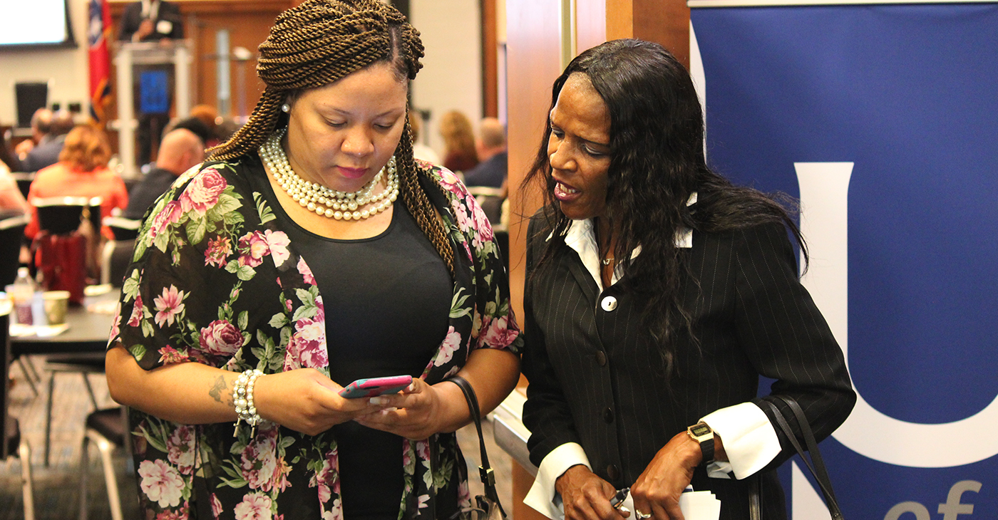 Lori Black (right) shares her information with a new contact interested in helping the 52-year-old ex-offender find work. The two met at a forum aimed at connecting employers with the formerly incarcerated. “My background don’t determine me,” a defiant but determined Black said. “Not today, it don’t.” (Photo: Lee Eric Smith)