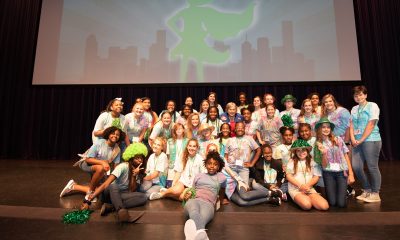Members of the G.I.R.L. Squad, GSNCA’s media team who helped plan and lead the event, pose on stage with astronaut and Girl Scout alum Jan Davis. (Provided)