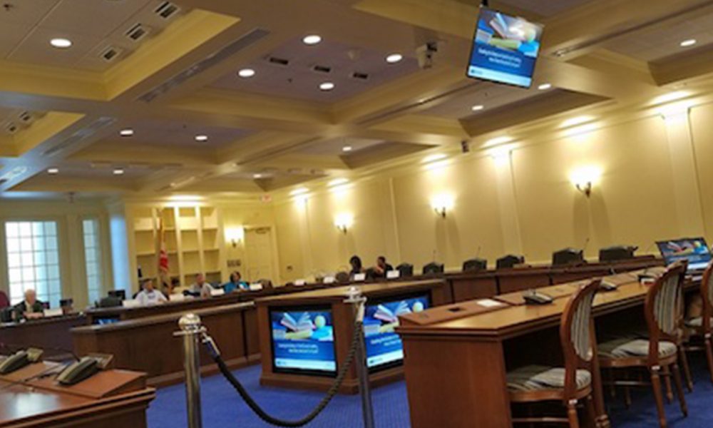 Danielle Farrie (right) presents an assessment of Maryland in comparison to other states on education funding in Annapolis on Aug. 1. (William J. Ford/The Washington Informer)