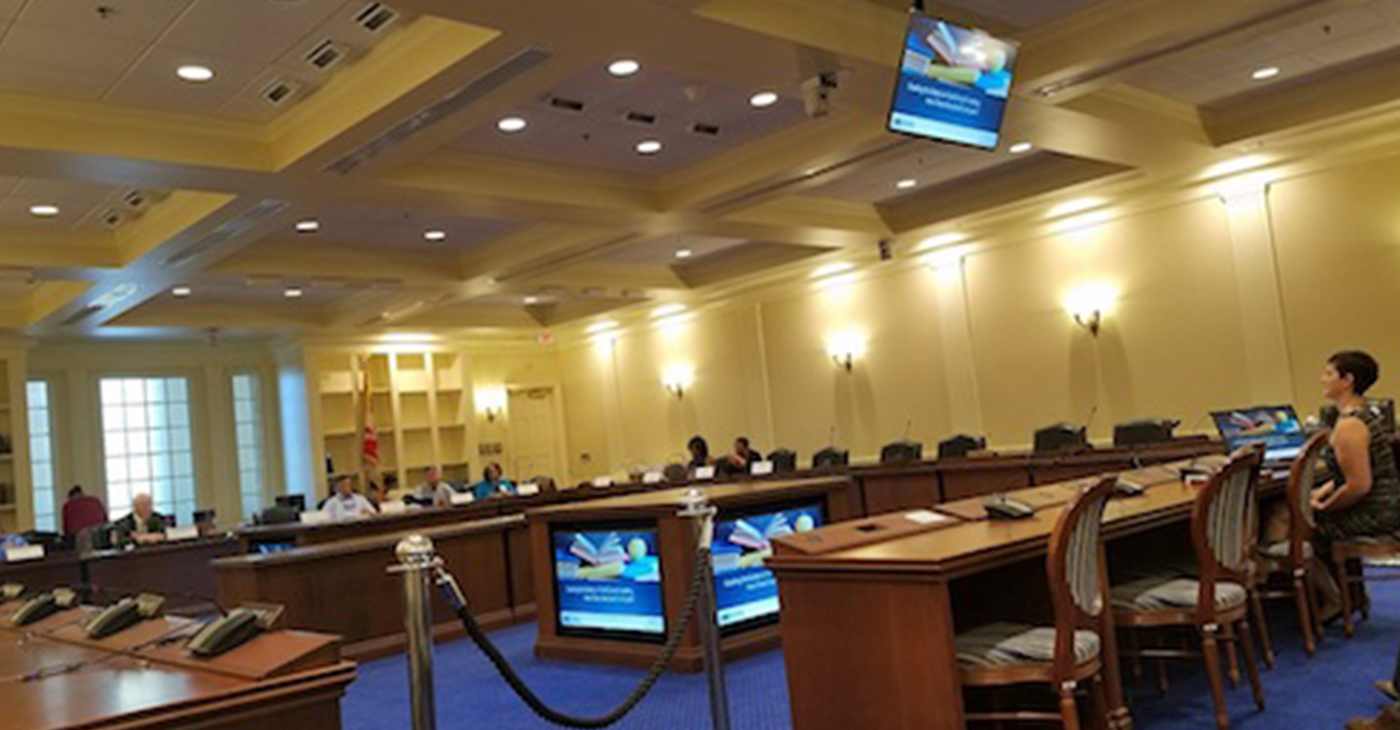Danielle Farrie (right) presents an assessment of Maryland in comparison to other states on education funding in Annapolis on Aug. 1. (William J. Ford/The Washington Informer)