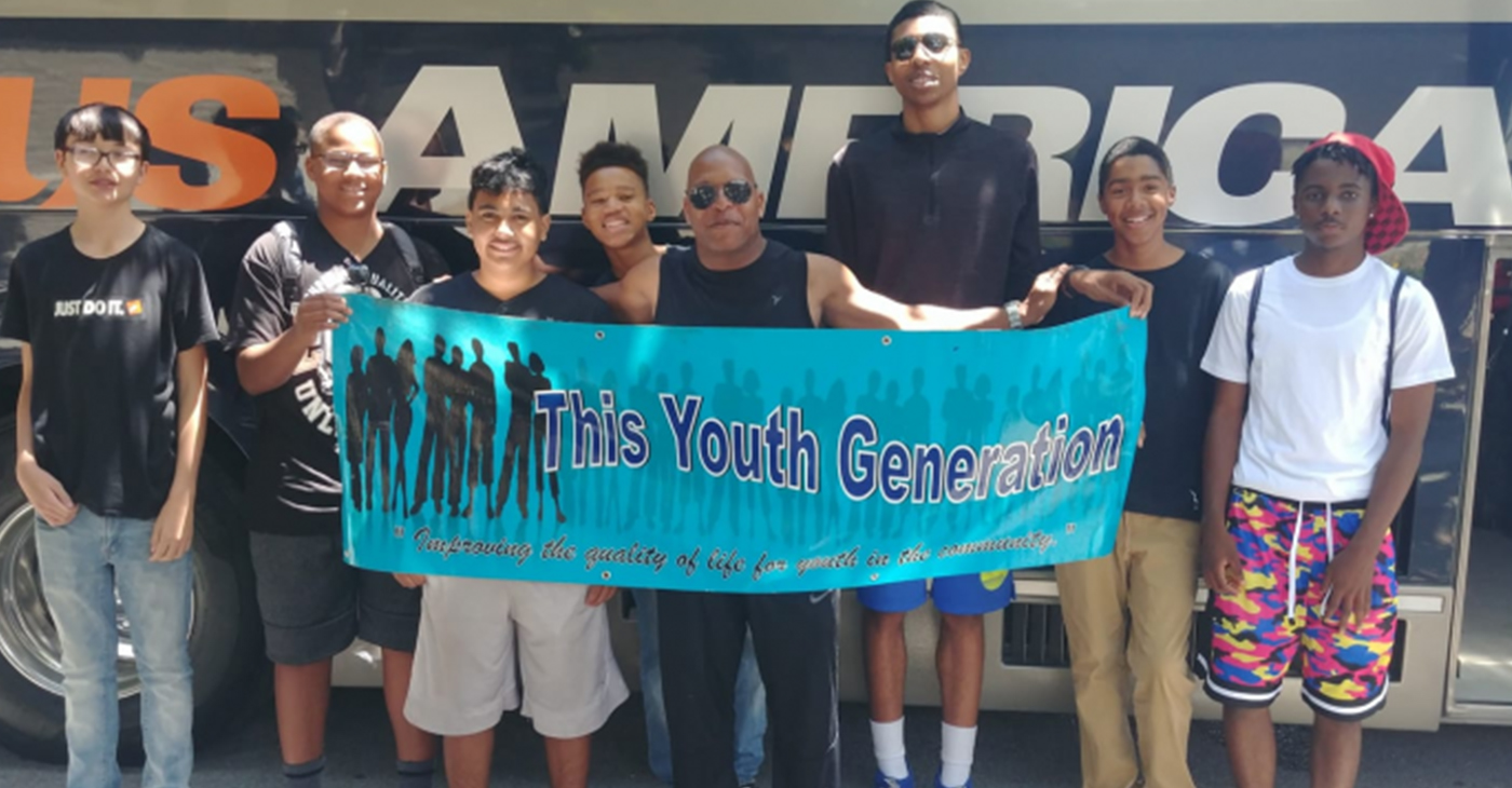 From left to right: Roman, Jimmy, J.J., Amir, Gabriel, Elijah and Chris pose with Deon D. Price, founder and executive director of This Youth Generation. The boys will board a bus headed to YMCA summer camp at Jones Gulch in La Honda for the 3rd year.