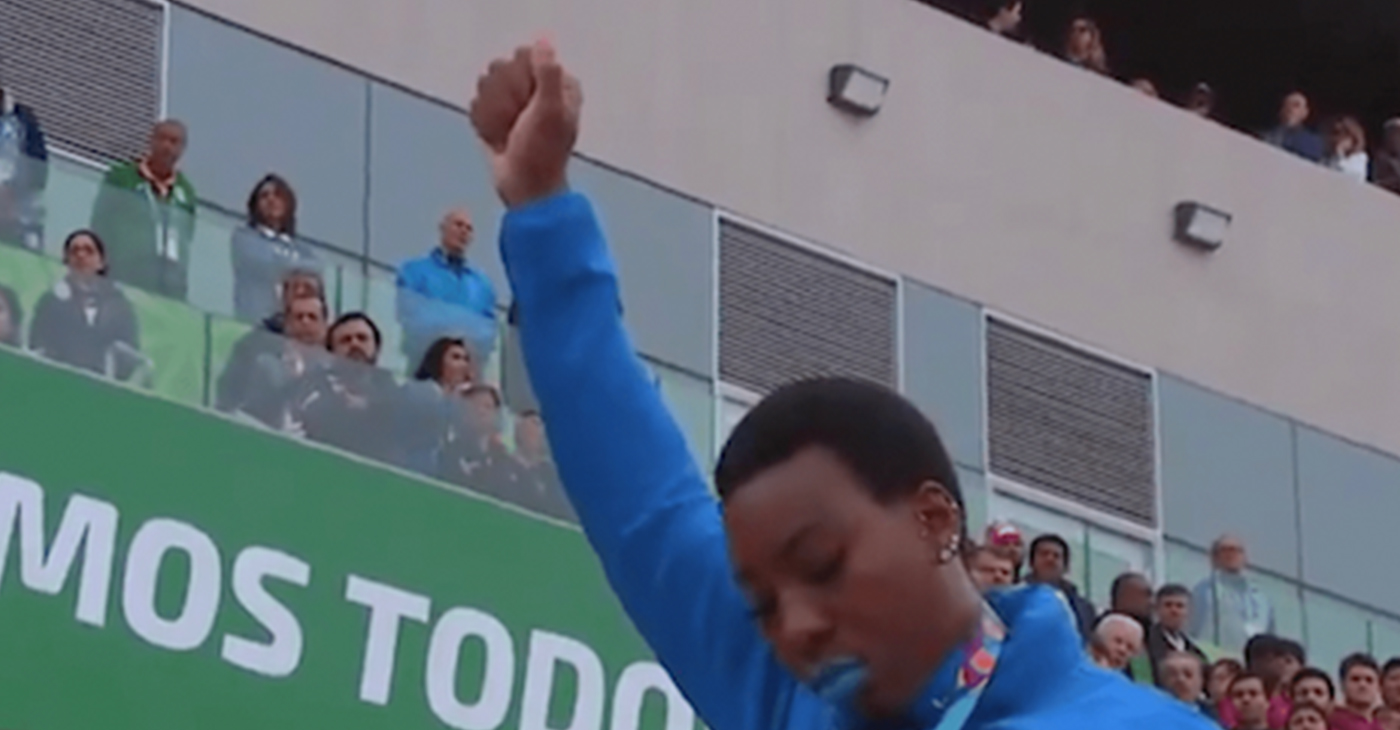 Gwen Berry protests at the Pan Am Games. (Screen grab courtesy of DiversityInc)