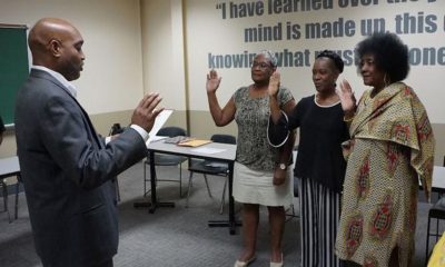 Micheal Bryant, former Martin University Alumni Association president, swore in (left to right) Linda Bellamy-Sims, Ann Pimpton and Dorothy Herron as new officers Aug. 24. (Photo by: Jim Buntin)
