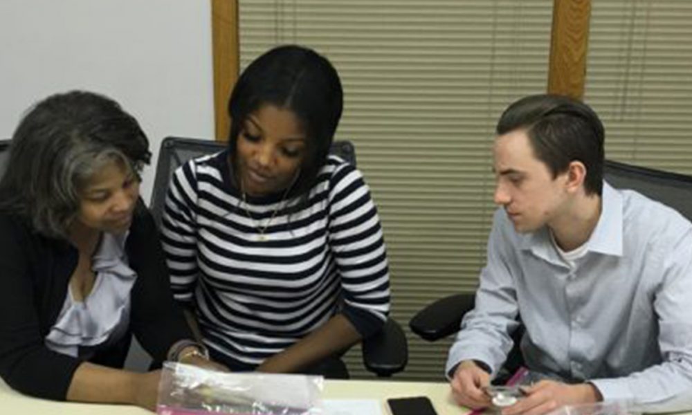 April Williams-Luster, Elise Miller and Kyle Bergfors examine a Narcan kit after a training session on how to administer the opioid overdose reversal spray at the Matteson office of Congresswoman Robin Kelly. The training session was conducted by Lindsay Wilson, health promotions coordinator with the Kankakee County Health Department.