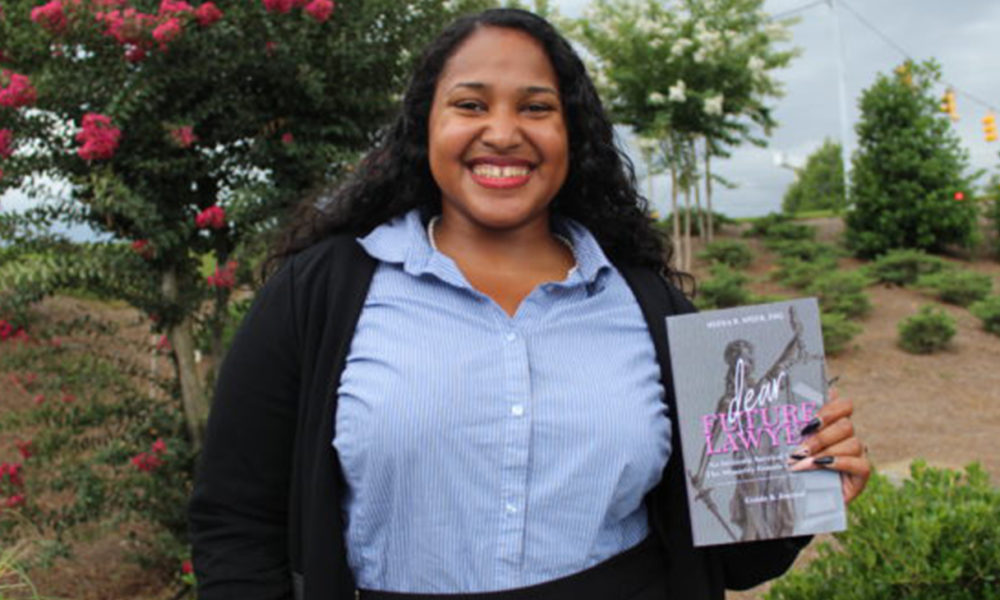Neena Speer with her book "Dear Future Lawyer: An Intimate Survival Guide for the Minority Female Law Student" (Photo by: Ameera Steward | The Birmingham Times