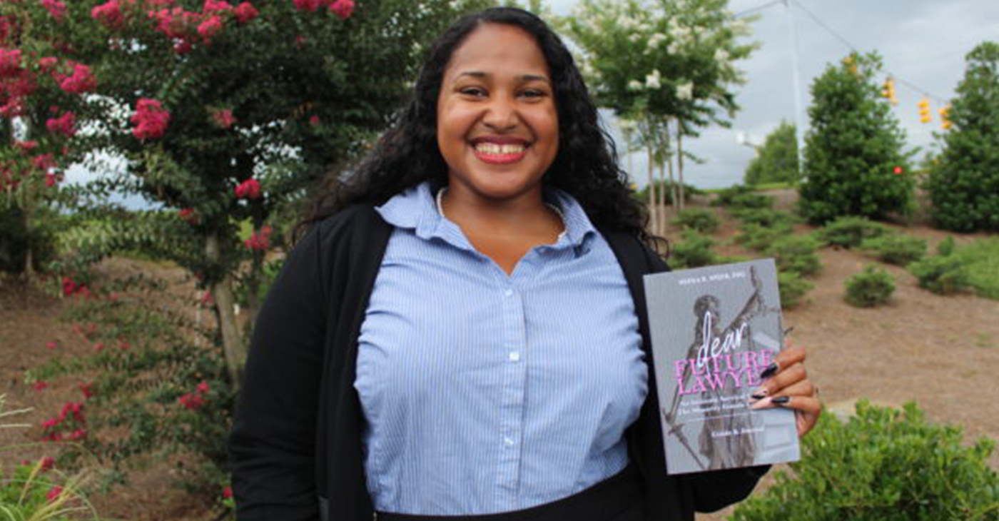 Neena Speer with her book "Dear Future Lawyer: An Intimate Survival Guide for the Minority Female Law Student" (Photo by: Ameera Steward | The Birmingham Times