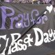 Fans carry a sign that reads, “Pray for El Paso & Dayton” during a march before a pro soccer match in Orlando on Tuesday.